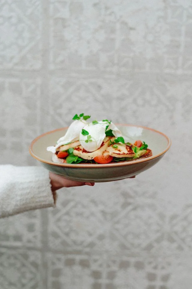 A person is holding a plate of food in their hand.