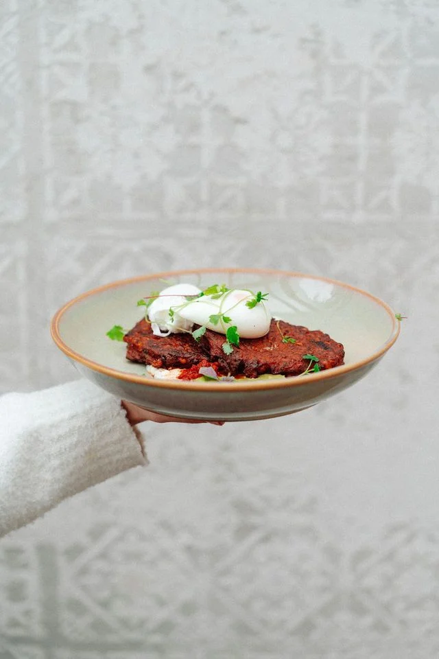 A person is holding a plate of food in their hand.