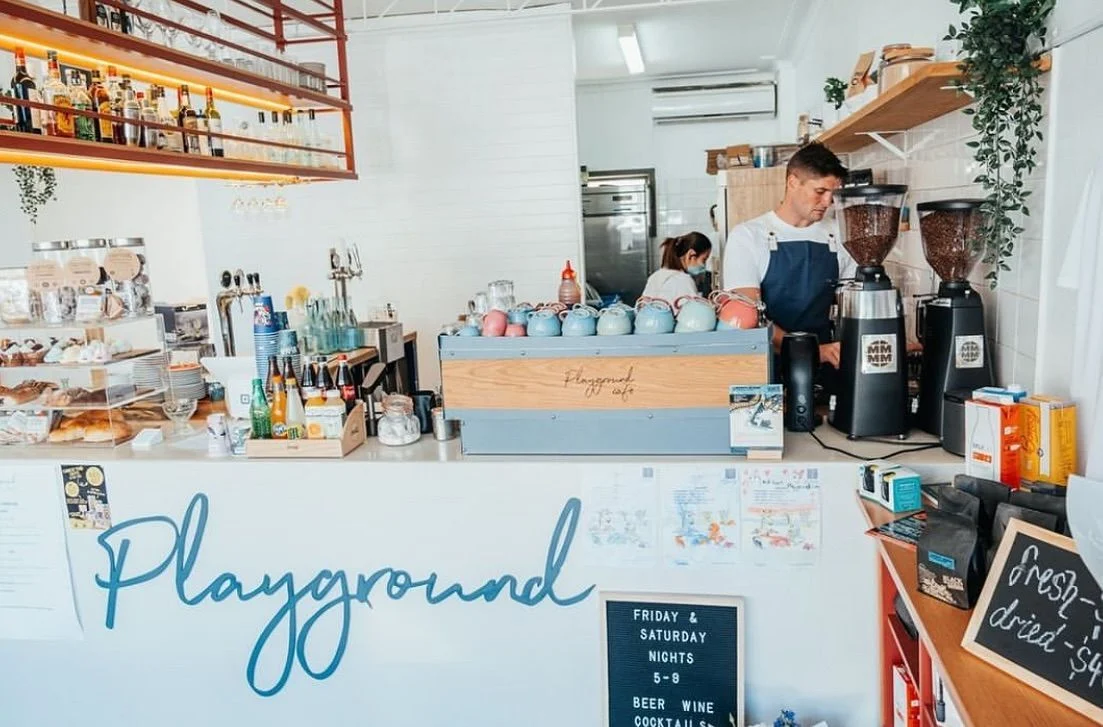 Staff behind Playground Cafe’s coffee counter