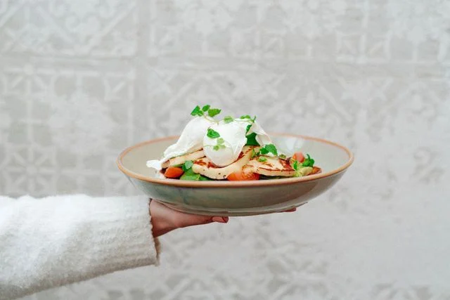 A person is holding a plate of food in their hand.