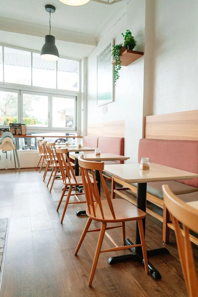 A row of tables and chairs in a restaurant.