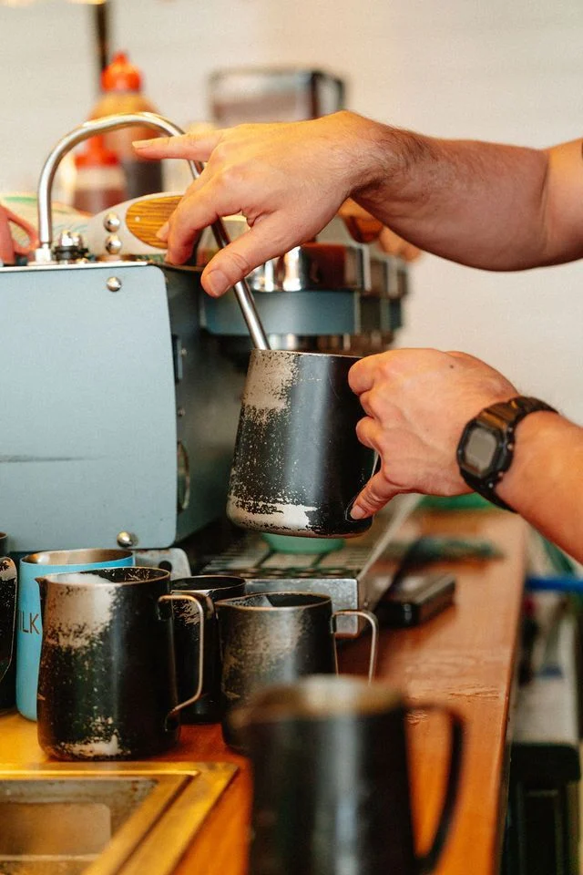 A barista working at the espresso machine